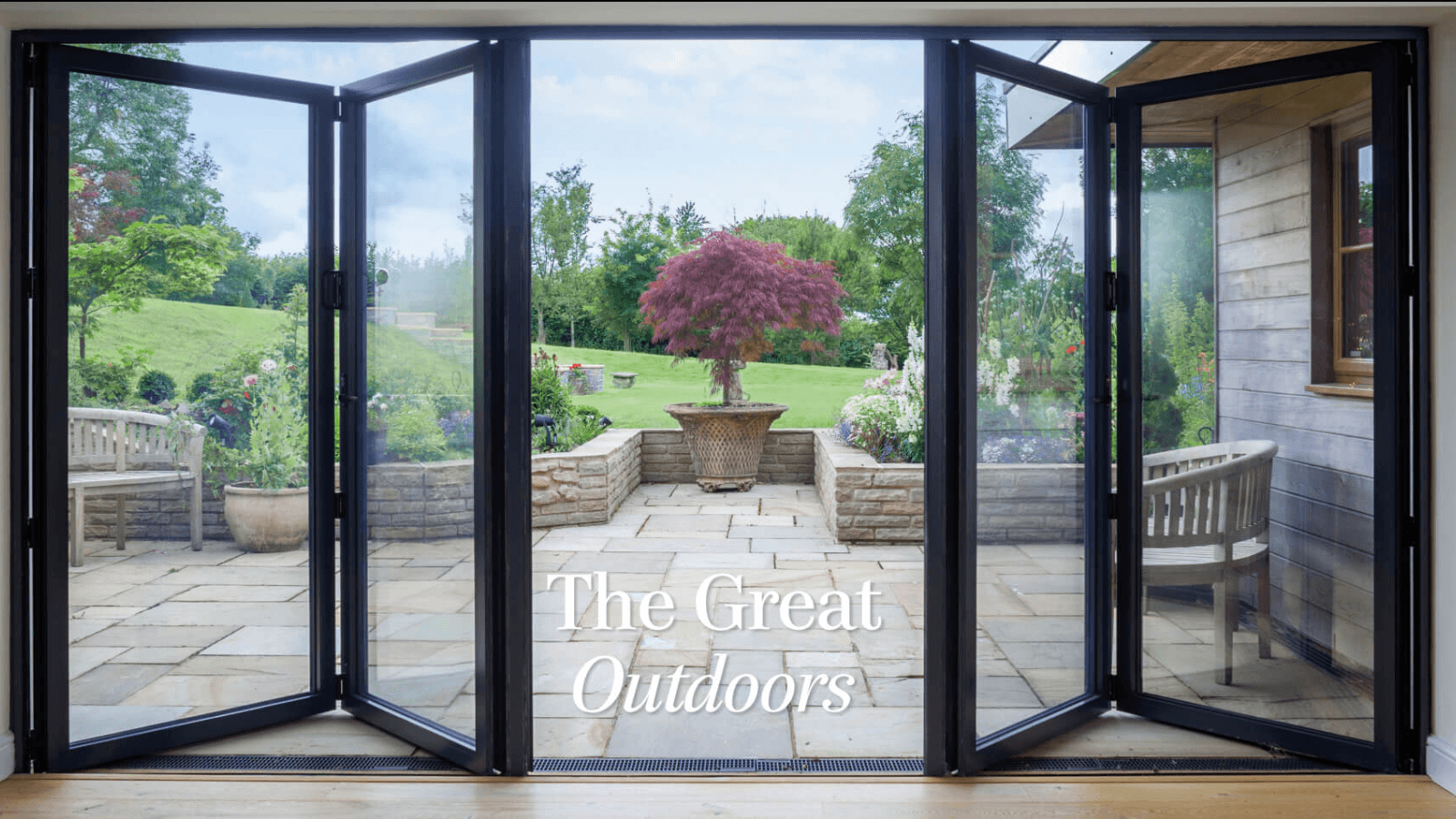 A bright, light-filled conservatory with wide glazing opening onto a Somerset garden